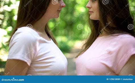 two attractive lesbian girlfriends passionately kissing and。